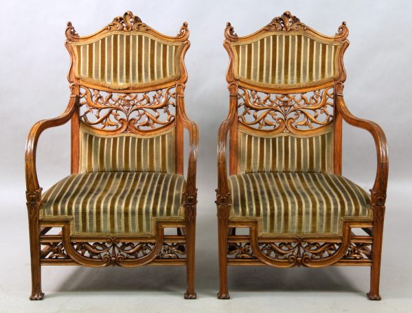 A Beautiful Pair of Early 20th Century Art Nouveau Carved Wood Arm Chairs with High Wavy Arms