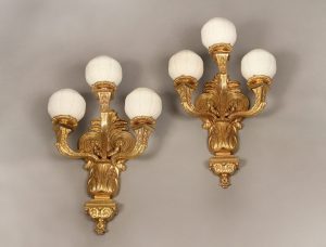 A Large Pair of Early 20th Century Gilt Bronze Three Light Arm Sconces and White Glass Globes