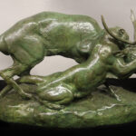 Statue of a cougar and stag locked in combat.