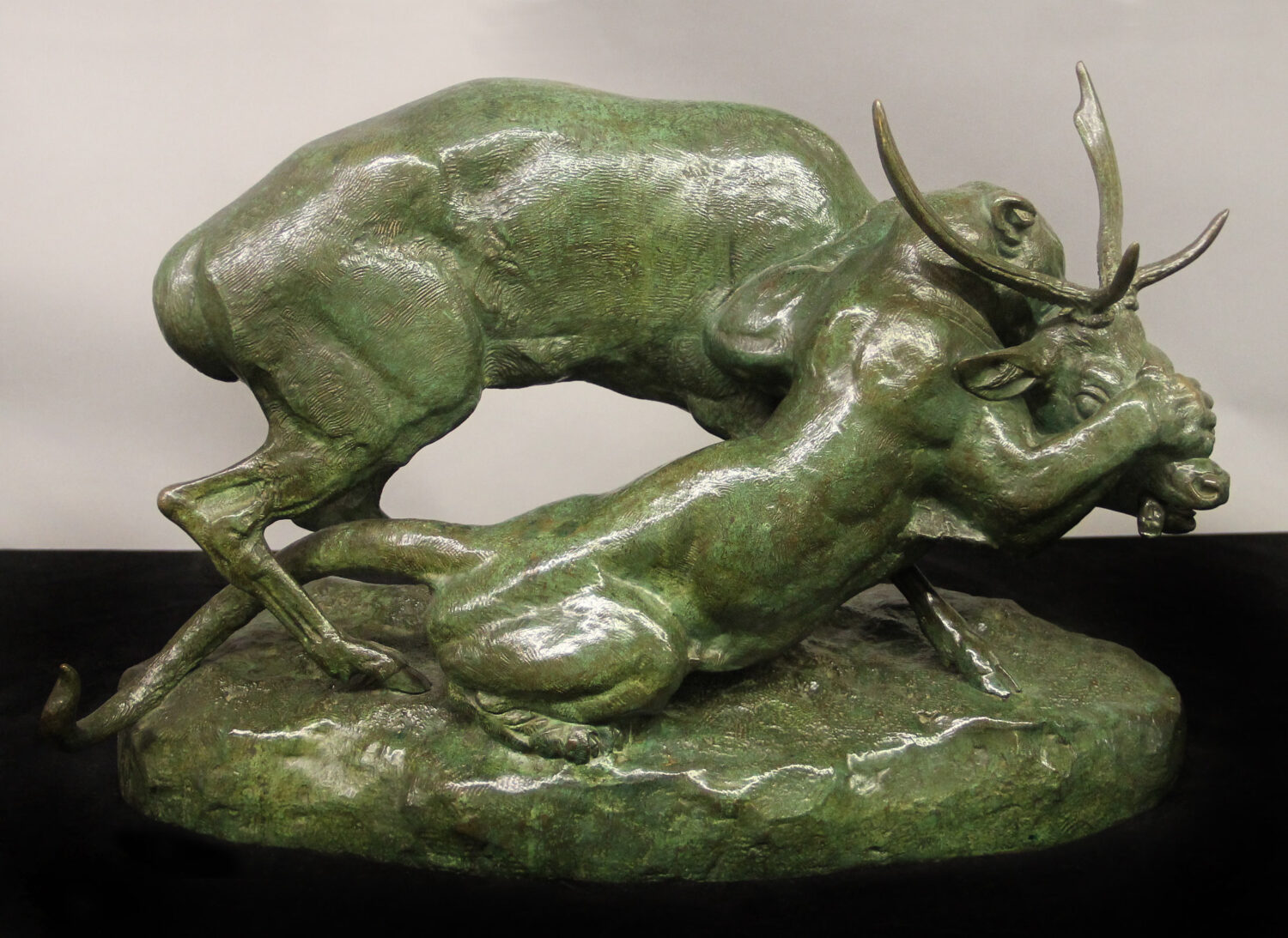 Statue of a cougar and stag locked in combat.