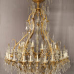 Bronze and cut crystal chandelier with forty eight lights.