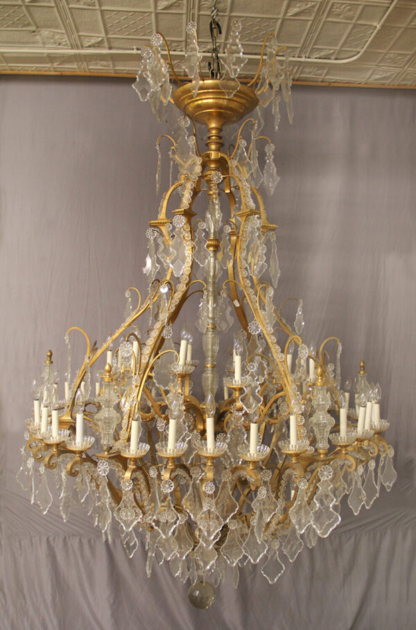 Bronze and cut crystal chandelier with forty eight lights.