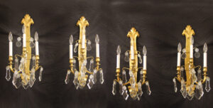 A Set of Four Late 19th / Early 20th Century Gilt Bronze and Crystal Four Light Sconces